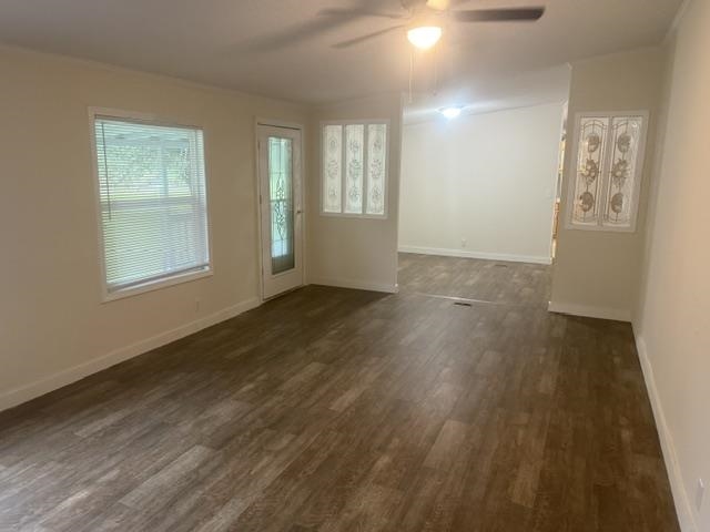 1100 Pine Top Road Toone, TN 38381 - Photo 4 of 40 Spacious interior featuring wood-finish flooring, white wall paint, multiple windows with blinds, and decorative transom windows