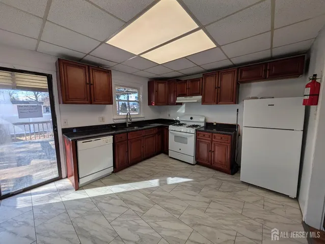 a kitchen with stainless steel appliances granite countertop a stove sink and cabinets