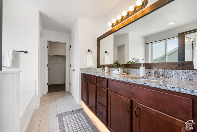 3456 South Linden Way Syracuse, UT 84075 - Photo 22 of 50 Primary en suite featuring double vanity, a garden tub, tile patterned flooring, an enclosed shower, and a walk in closet