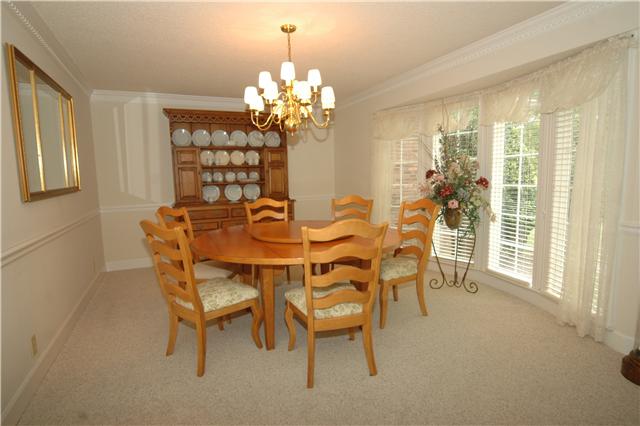 The formal Dining Room is accentuated with dentil crown molding and a chair rail.