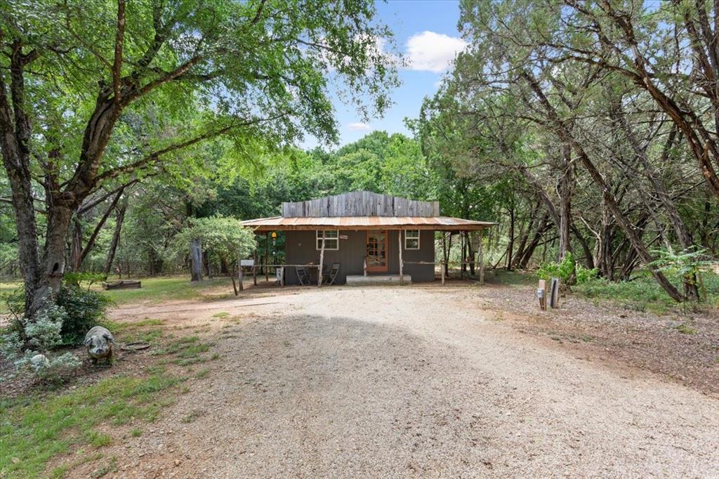 15988 Wortham Bend Road China Spring, TX 76633 - Photo 33 of 40 Ranch-style dwelling with a corrugated metal roof and a covered porch