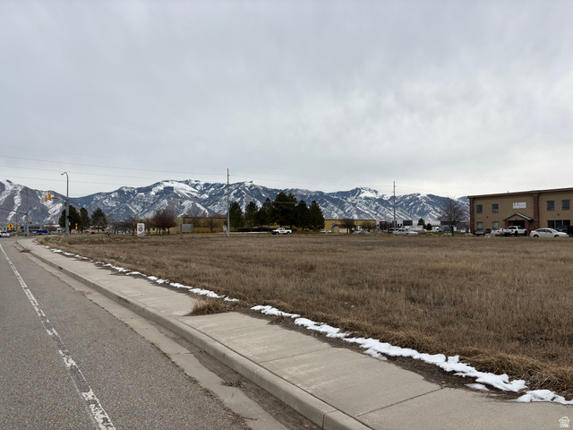 1400 South 940 West Logan, UT 84321 - Photo 1 of 1 View of asphalt street featuring a mountain view, sidewalks, and curbs