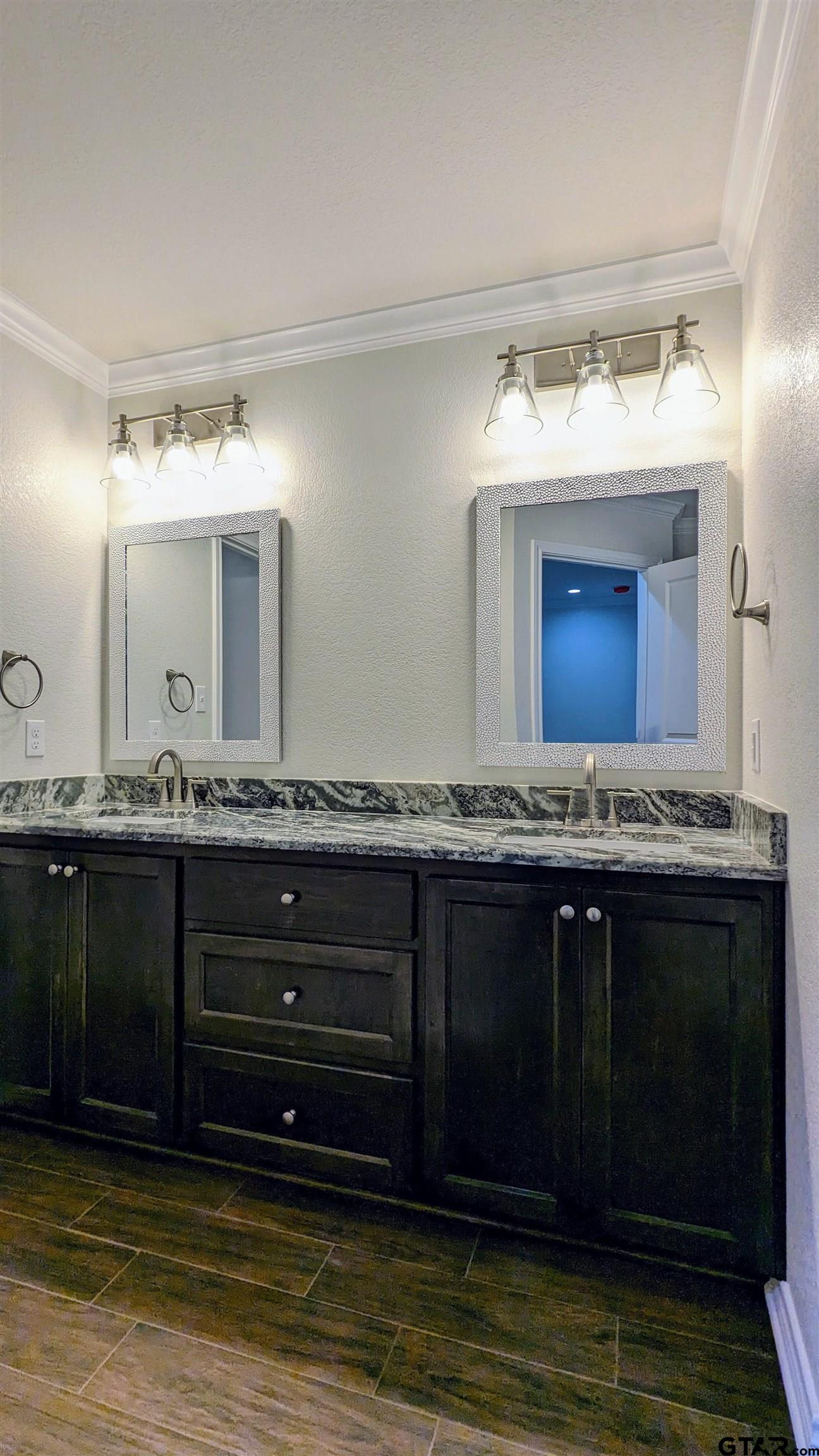 11086 County Road 167, Unit 11 Tyler, TX 75703 - Photo 11 of 20 a bathroom with a sink and a large mirror