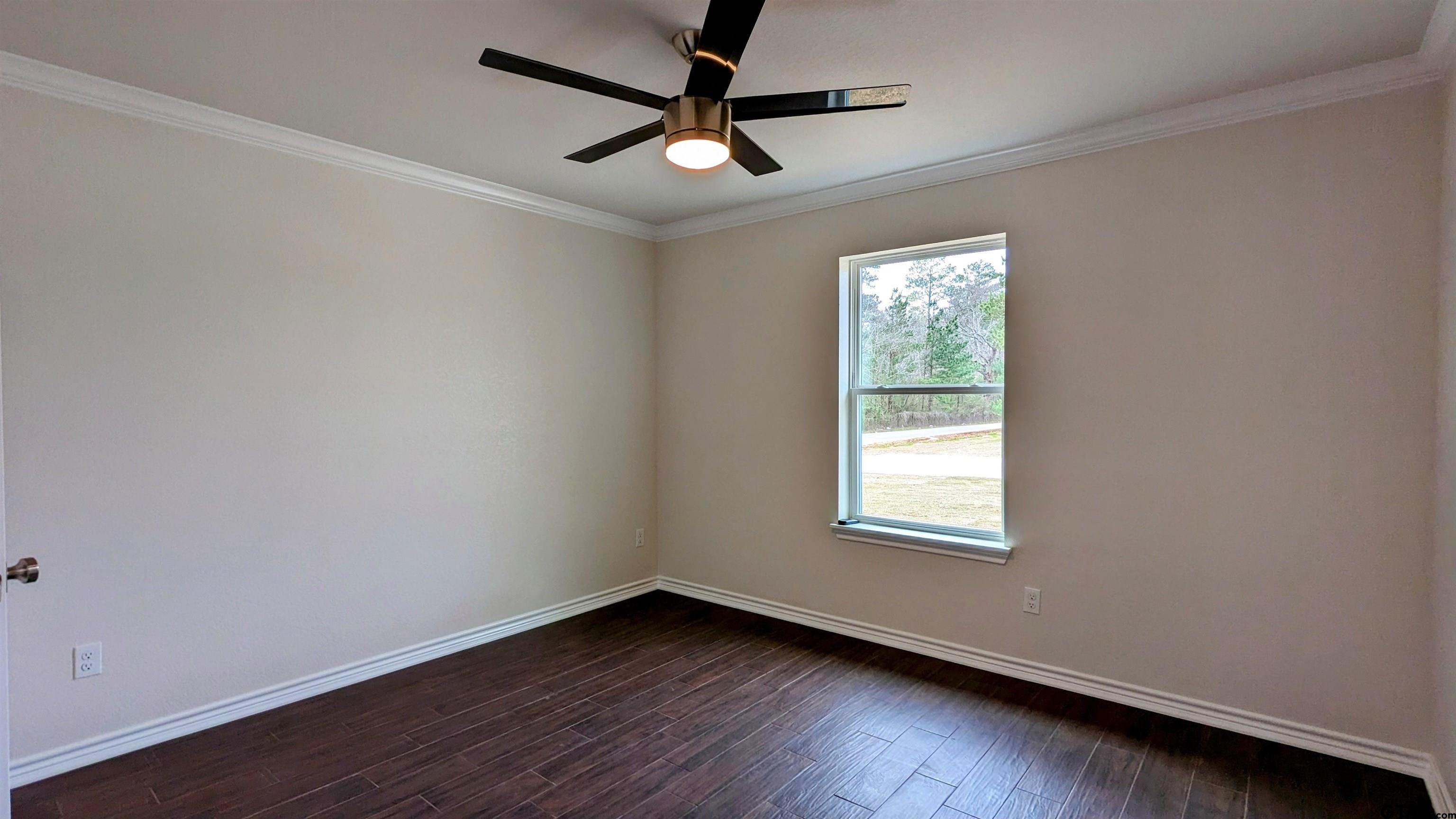 11086 County Road 167, Unit 11 Tyler, TX 75703 - Photo 13 of 20 a view of an empty room with wooden floor and a window