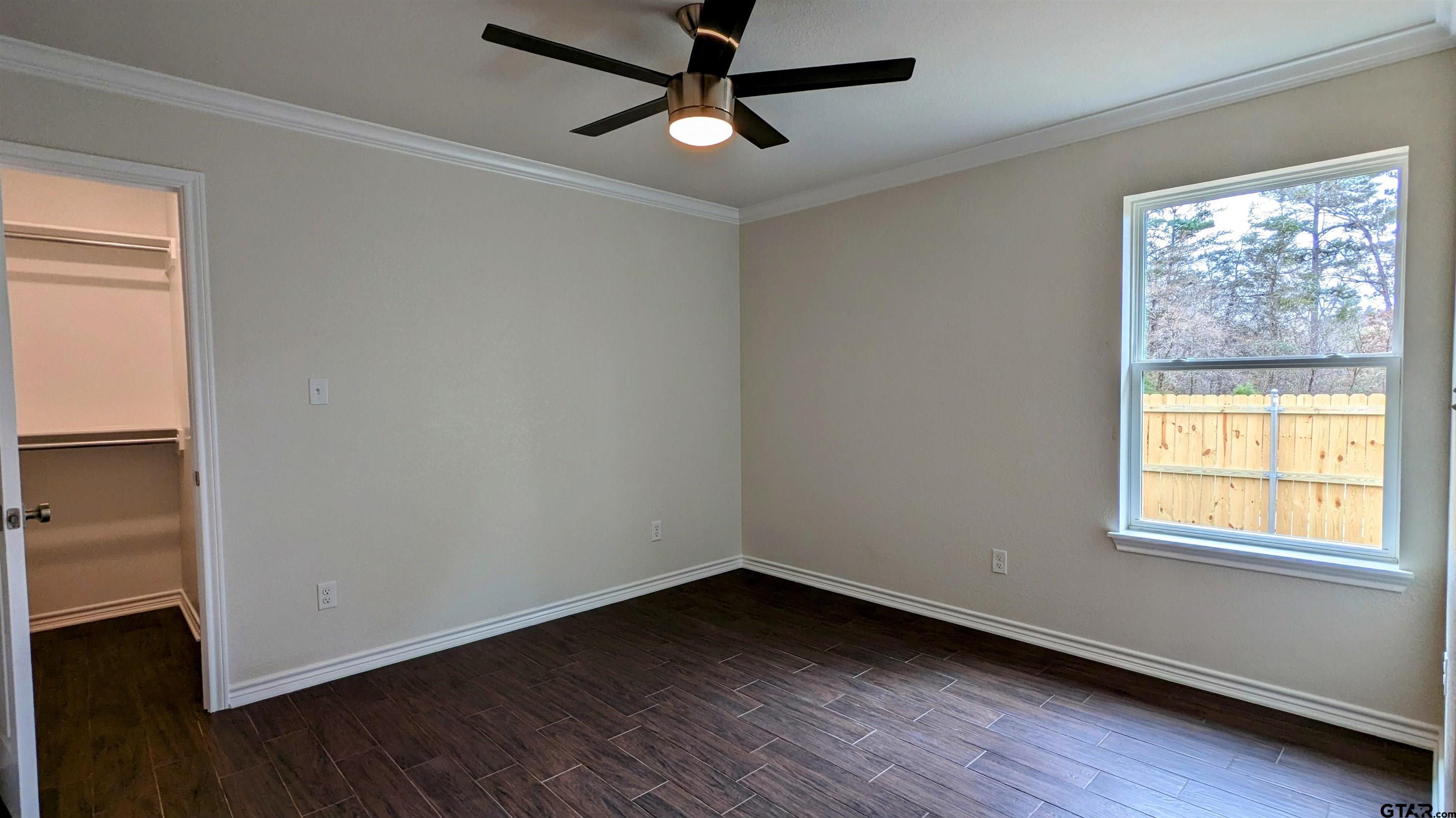 11086 County Road 167, Unit 11 Tyler, TX 75703 - Photo 16 of 20 a view of an empty room with wooden floor and a window