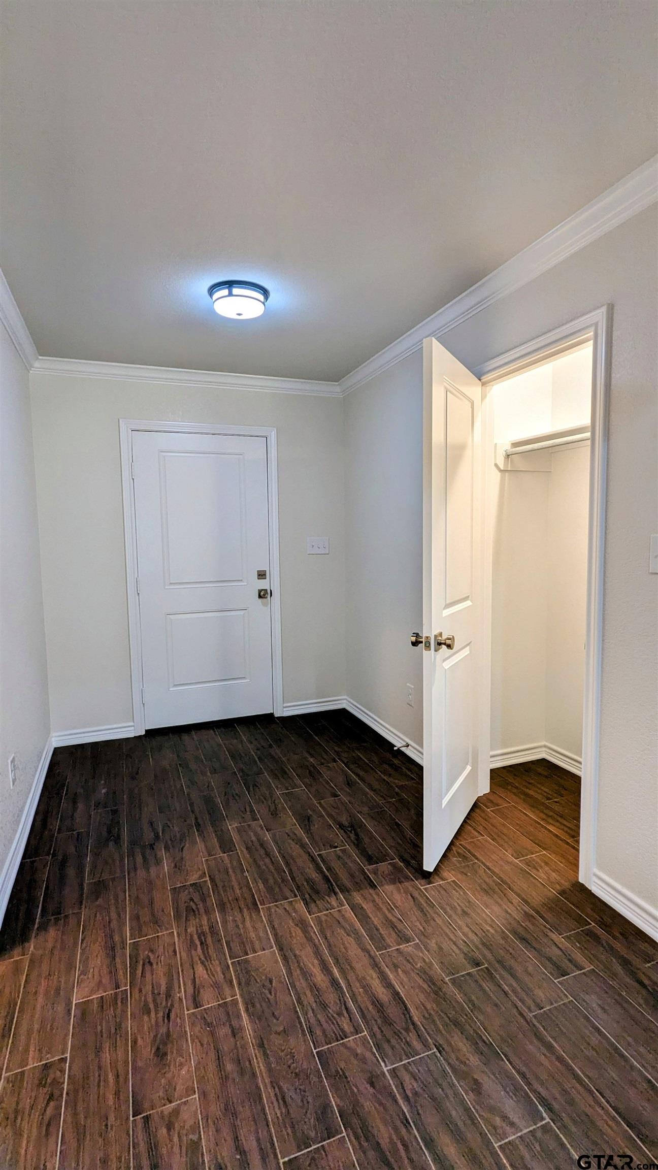 11086 County Road 167, Unit 11 Tyler, TX 75703 - Photo 7 of 20 a view of an empty room with wooden floor