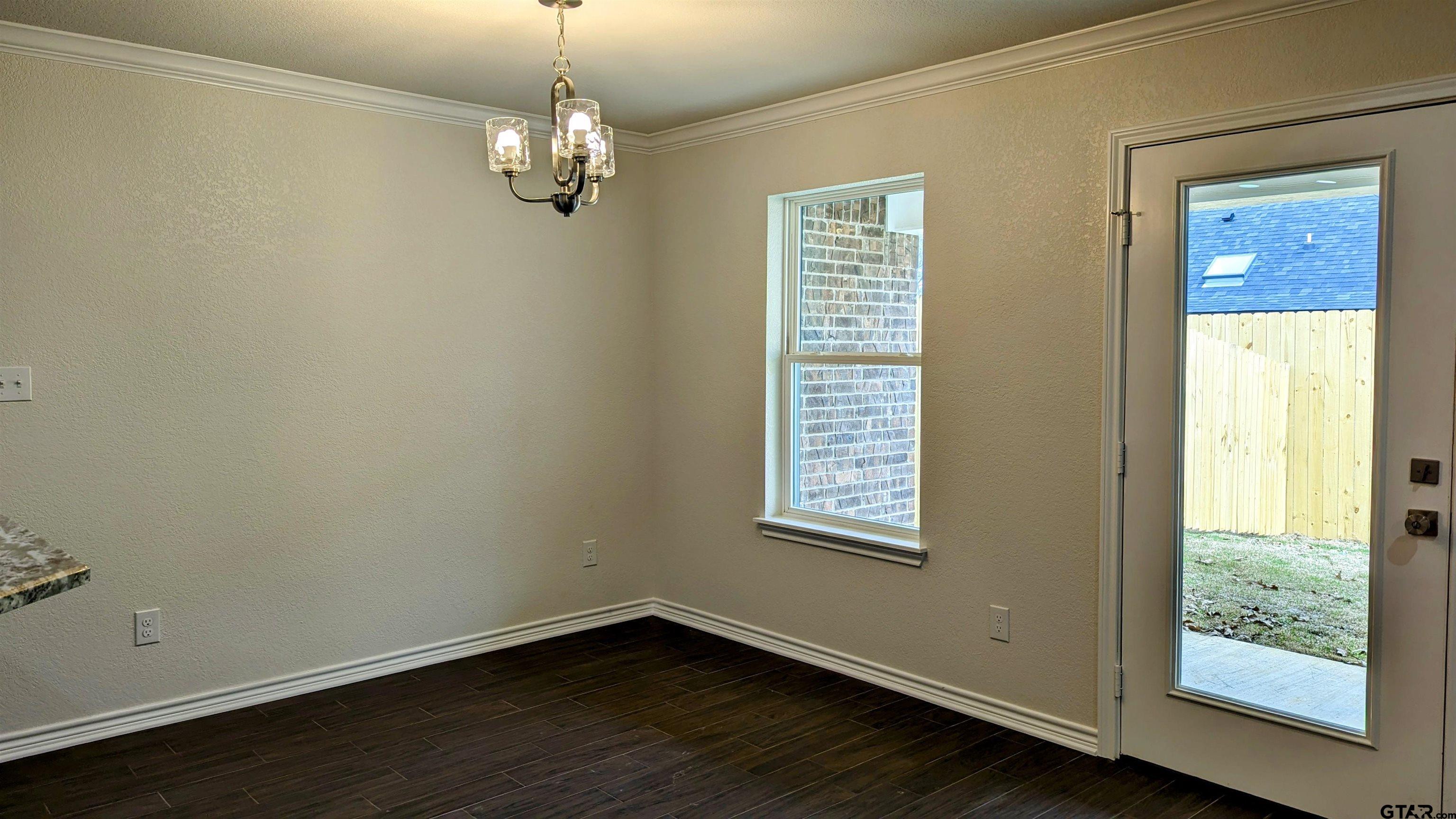 11086 County Road 167, Unit 11 Tyler, TX 75703 - Photo 9 of 20 a view of an empty room with wooden floor and a window