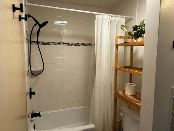 a bathroom with a glass shower door