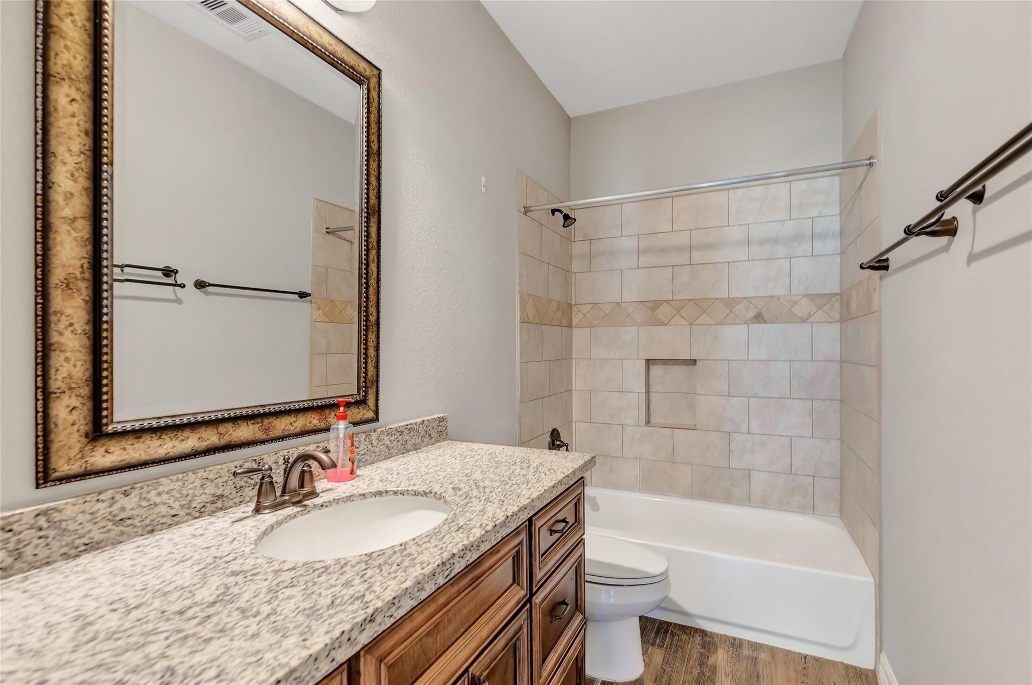 27684 Rio Blanco Drive Splendora, TX 77372 - Photo 15 of 37 a bathroom with a granite countertop bathtub shower sink mirror and toilet