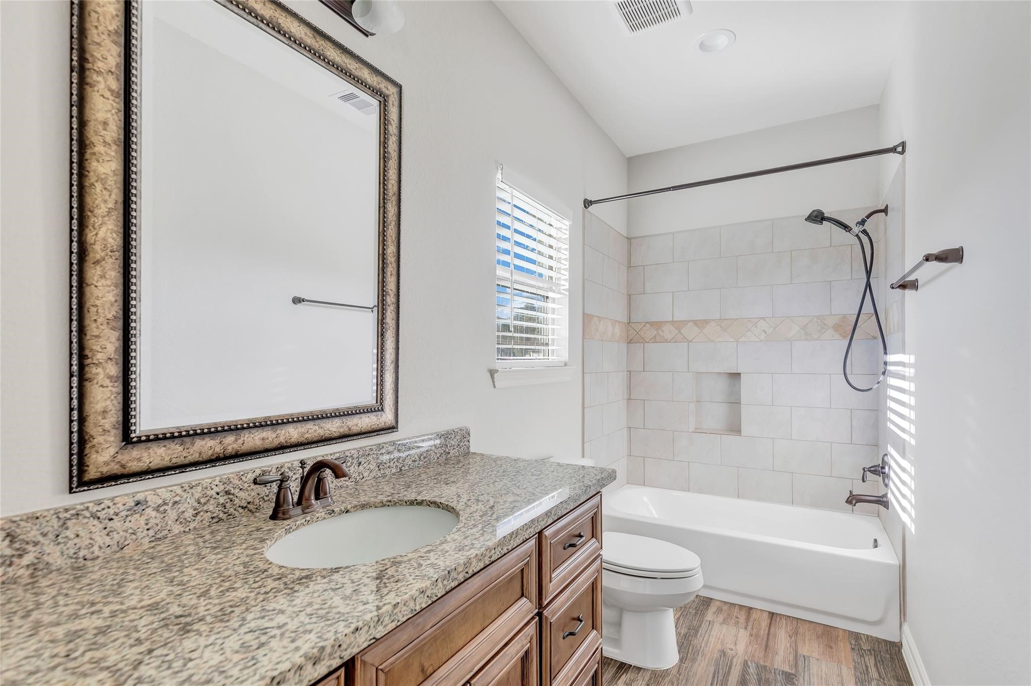 27684 Rio Blanco Drive Splendora, TX 77372 - Photo 19 of 37 a bathroom with a granite countertop sink toilet mirror and shower
