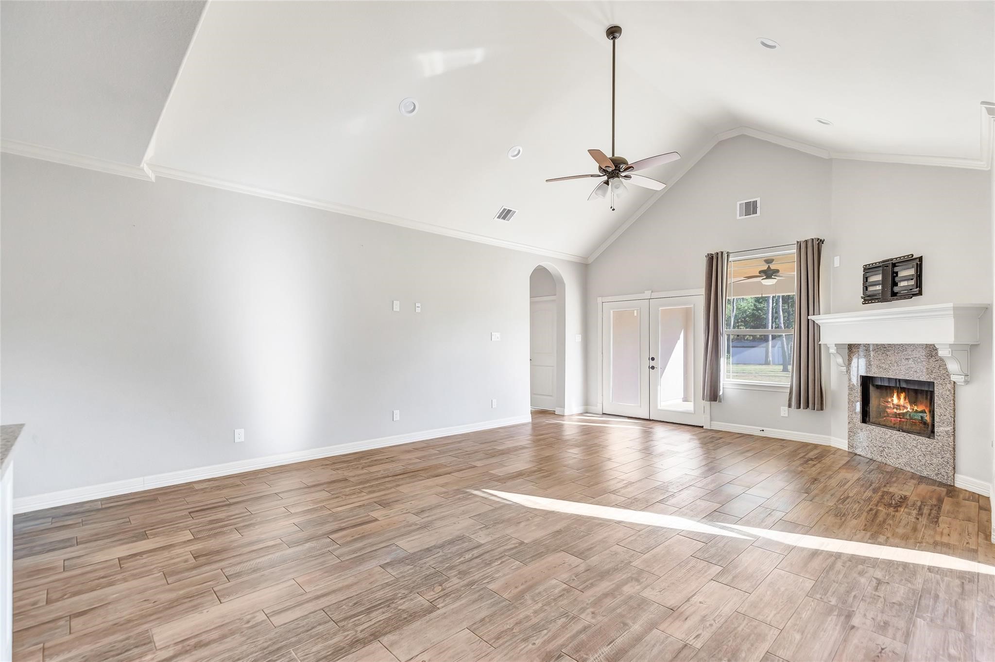 27684 Rio Blanco Drive Splendora, TX 77372 - Photo 8 of 37 a view of an empty room with wooden floor fireplace and a window