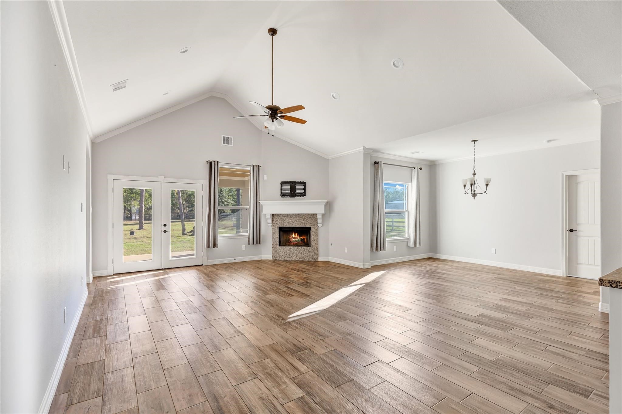 27684 Rio Blanco Drive Splendora, TX 77372 - Photo 9 of 37 a view of an empty room with window and wooden floor