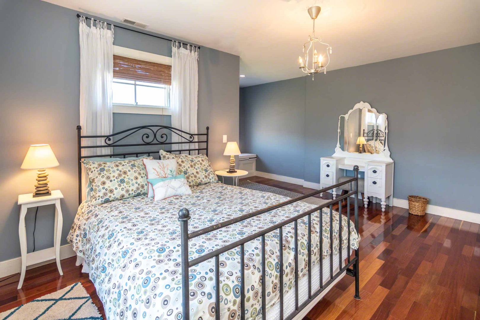 50 Red Pony Road Vineyard Haven, MA 02568 - Photo 18 of 28 a bedroom with a bed and wooden floor