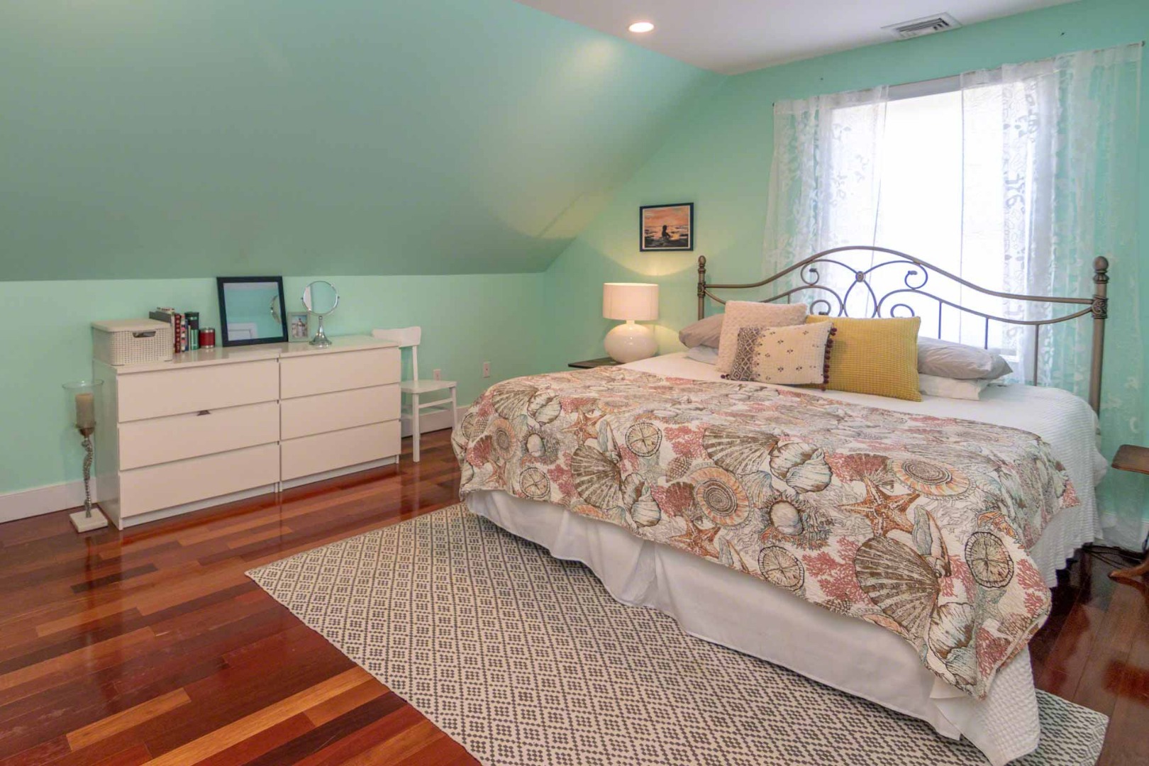 50 Red Pony Road Vineyard Haven, MA 02568 - Photo 21 of 28 a bedroom with a bed next to a window with a sink and mirror