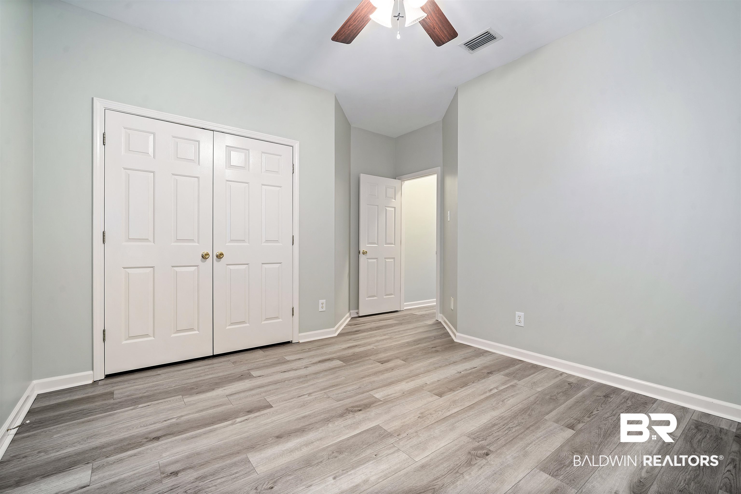 615 Summerlake Place Mobile, AL 36608 - Photo 29 of 35 Unfurnished bedroom featuring light wood finished floors, a ceiling fan, and a closet