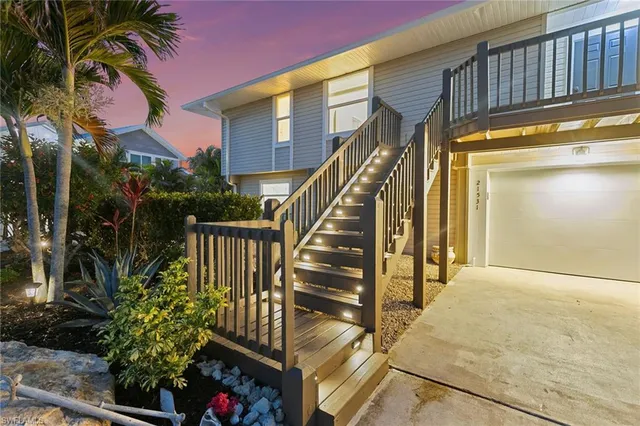 a view of staircase with railing and a potted plant