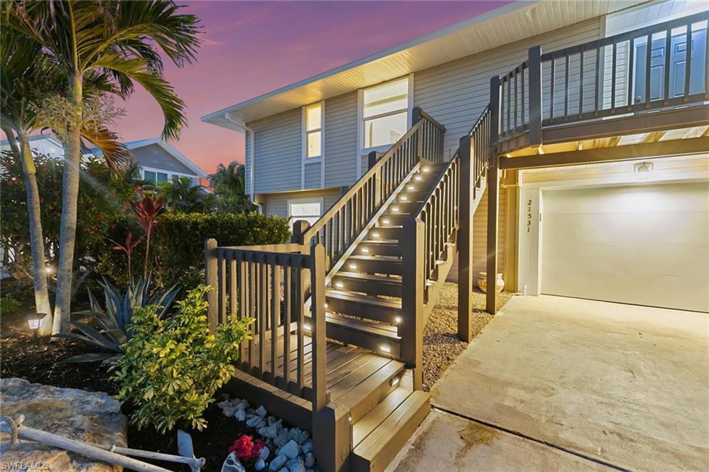 a view of staircase with railing and a potted plant