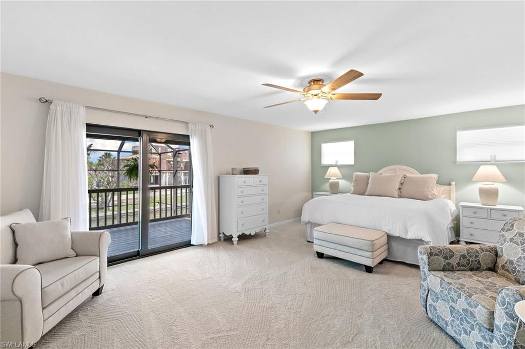 21531 Madera Road Fort Myers Beach, FL 33931 - Photo 12 of 49 a spacious bedroom with a bed and a couch