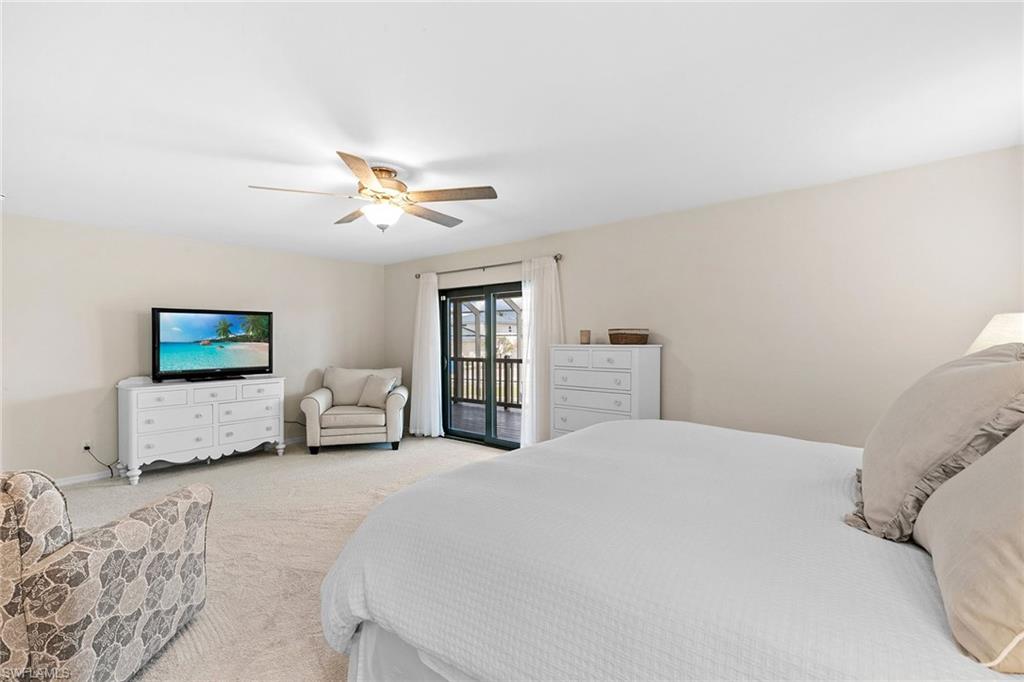 21531 Madera Road Fort Myers Beach, FL 33931 - Photo 13 of 49 a bedroom with a bed and a chandelier