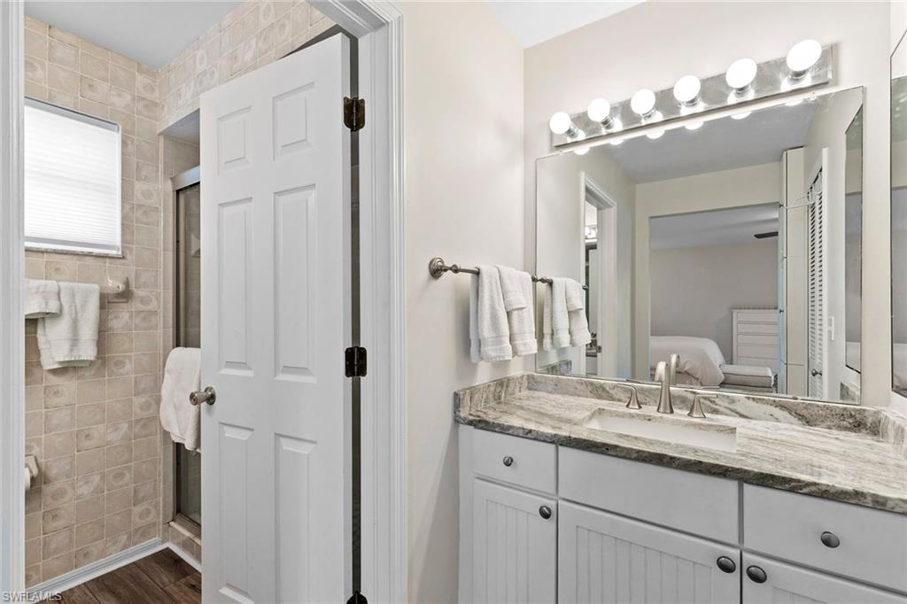 21531 Madera Road Fort Myers Beach, FL 33931 - Photo 14 of 49 a bathroom with a granite countertop shower sink and mirror