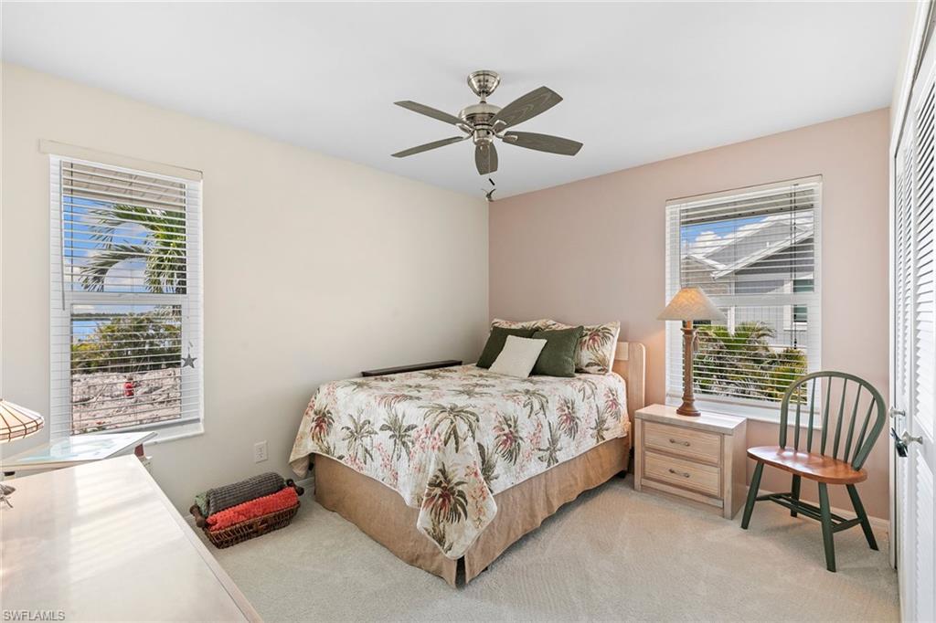 21531 Madera Road Fort Myers Beach, FL 33931 - Photo 15 of 49 a bedroom with a bed and a large window