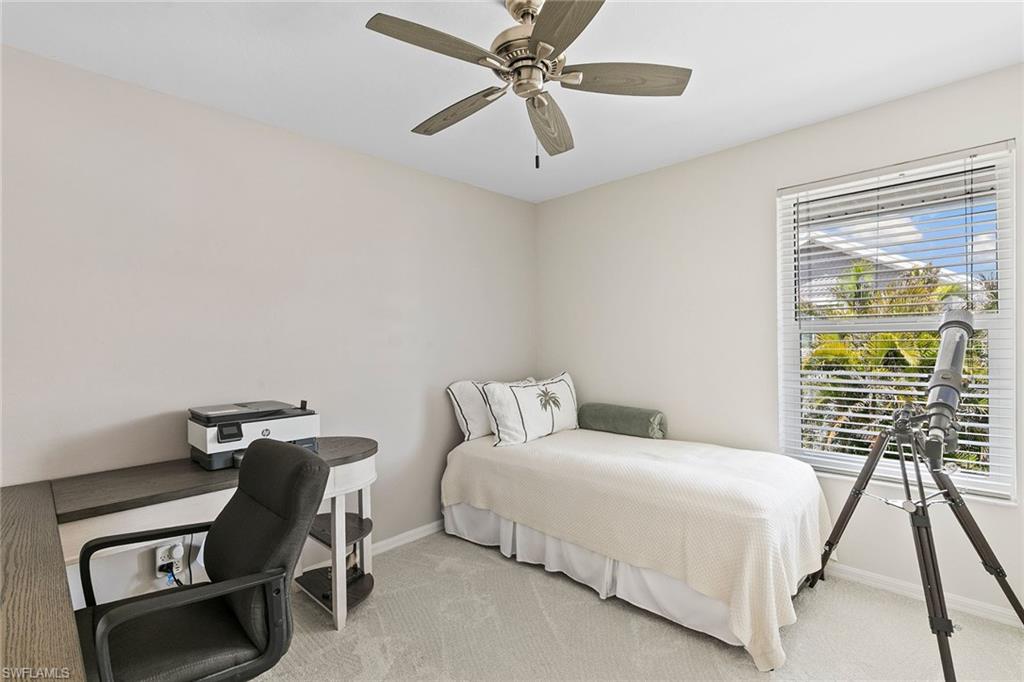 21531 Madera Road Fort Myers Beach, FL 33931 - Photo 16 of 49 a bedroom with a bed and a chandelier