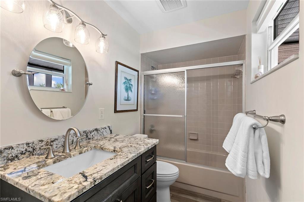 21531 Madera Road Fort Myers Beach, FL 33931 - Photo 17 of 49 a bathroom with a granite countertop sink toilet and shower