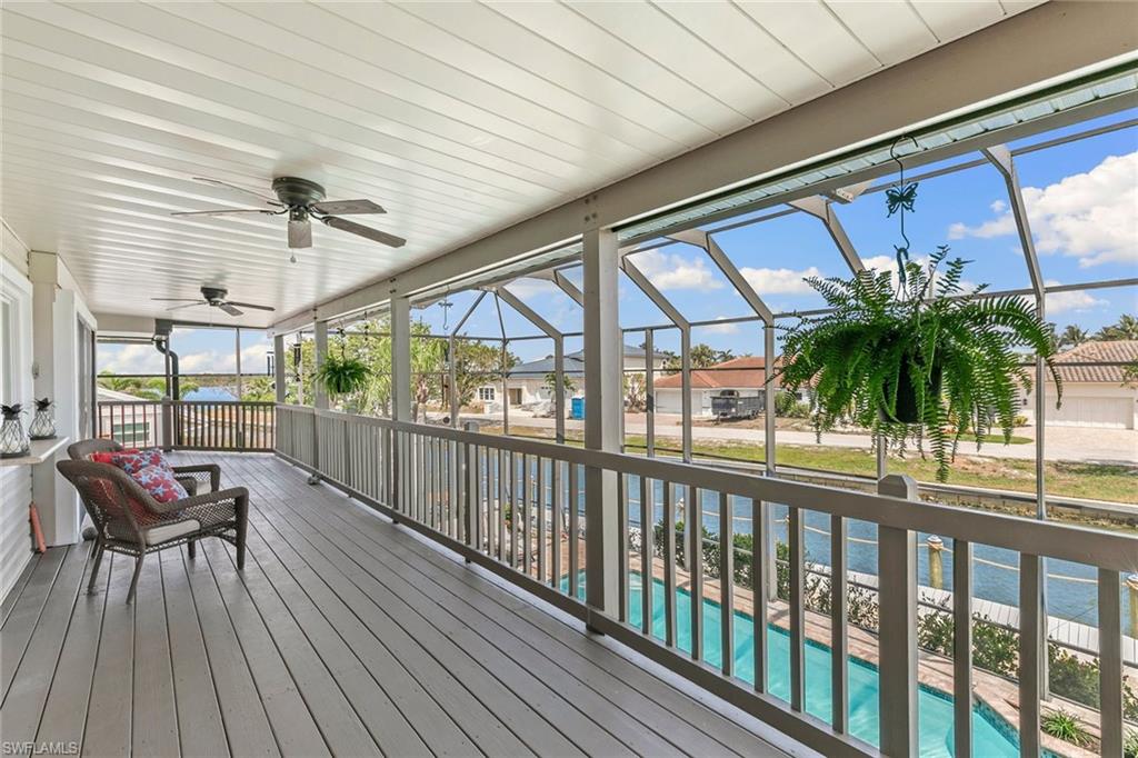 21531 Madera Road Fort Myers Beach, FL 33931 - Photo 19 of 49 a view of a porch with furniture and a yard