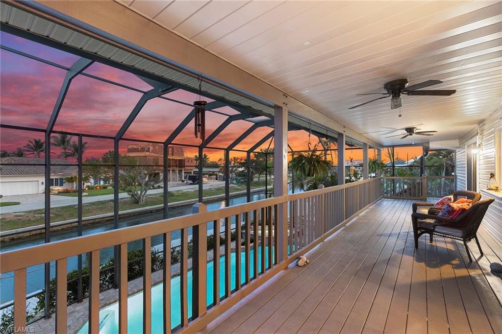 21531 Madera Road Fort Myers Beach, FL 33931 - Photo 20 of 49 a view of a balcony with furniture and wooden floor