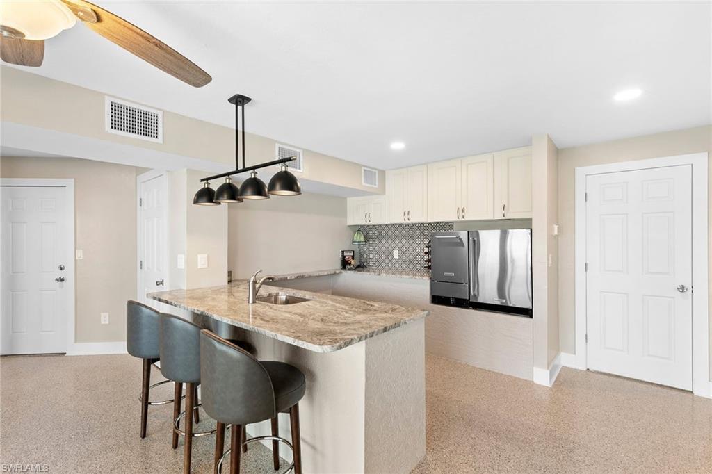 21531 Madera Road Fort Myers Beach, FL 33931 - Photo 24 of 49 a kitchen with a table and chairs in it