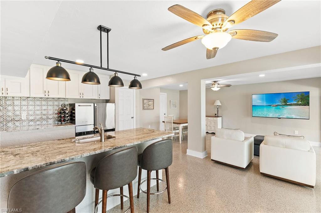 21531 Madera Road Fort Myers Beach, FL 33931 - Photo 25 of 49 a kitchen with stainless steel appliances granite countertop a sink a stove and refrigerator