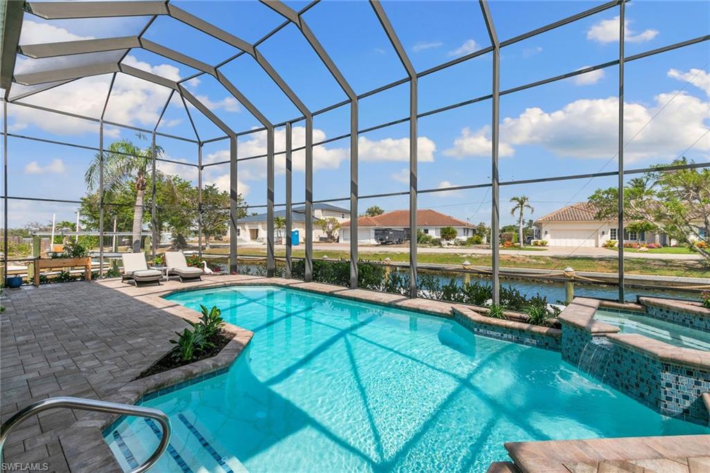 21531 Madera Road Fort Myers Beach, FL 33931 - Photo 28 of 49 a view of a swimming pool with a porch