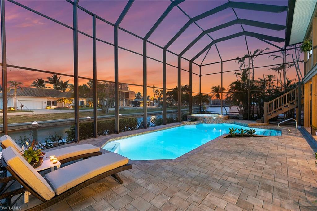 21531 Madera Road Fort Myers Beach, FL 33931 - Photo 32 of 49 a patio with water table and chairs