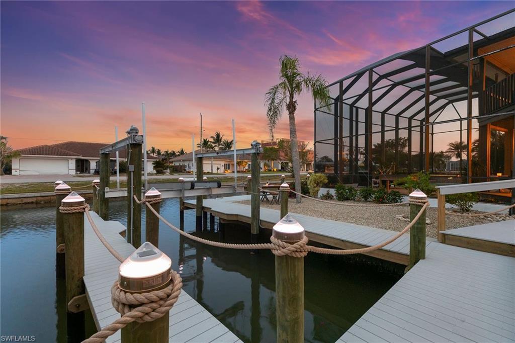 21531 Madera Road Fort Myers Beach, FL 33931 - Photo 37 of 49 a view of a patio with couches table and chairs