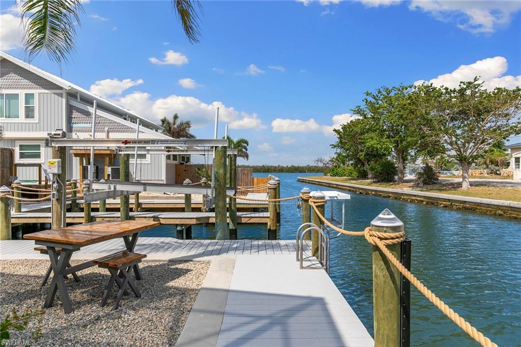 21531 Madera Road Fort Myers Beach, FL 33931 - Photo 38 of 49 a view of a patio with chairs and wooden fence