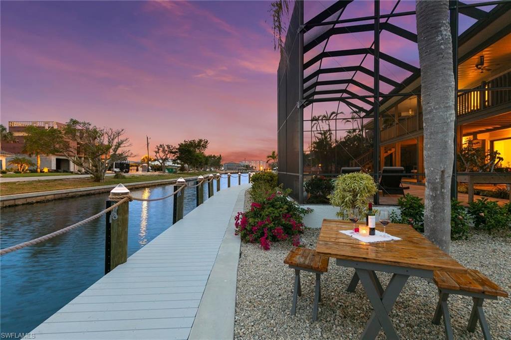 21531 Madera Road Fort Myers Beach, FL 33931 - Photo 39 of 49 a terrace with outdoor seating and wooden floor