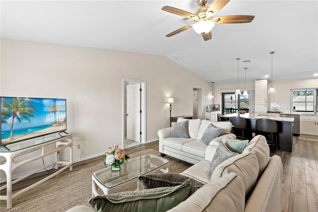 21531 Madera Road Fort Myers Beach, FL 33931 - Photo 4 of 49 a living room with furniture kitchen view and a chandelier