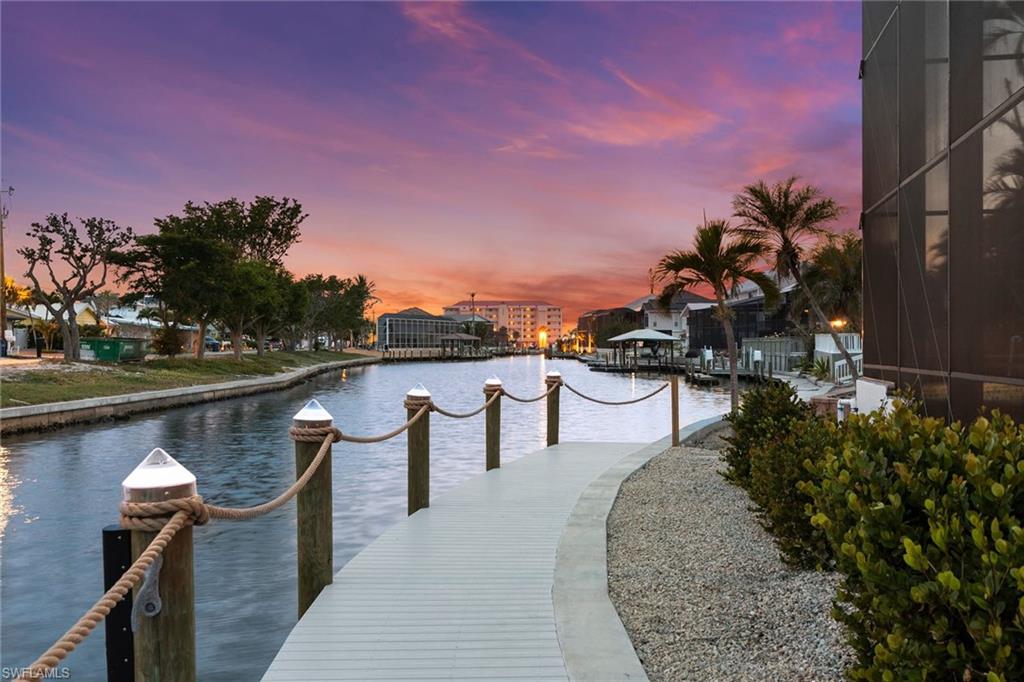 21531 Madera Road Fort Myers Beach, FL 33931 - Photo 42 of 49 a swimming pool with outdoor seating and yard in the back