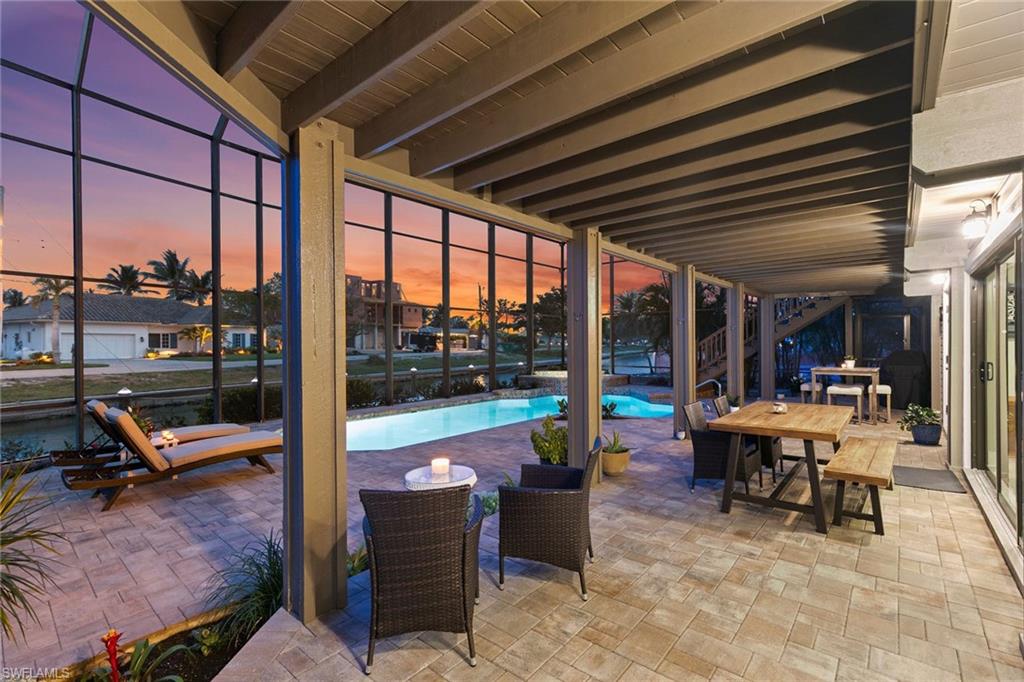 21531 Madera Road Fort Myers Beach, FL 33931 - Photo 43 of 49 a view of a swimming pool with chairs in patio