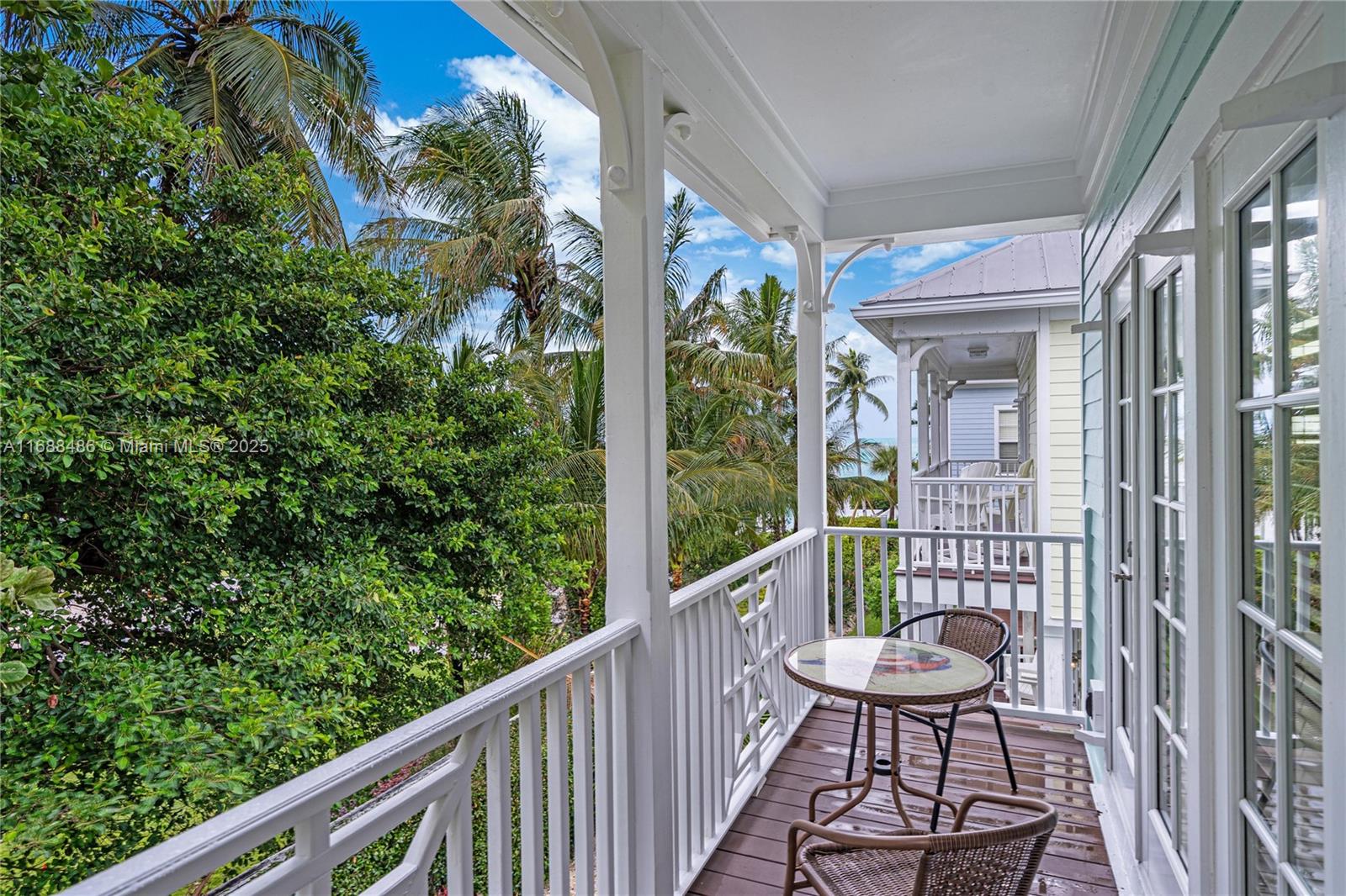 120 Anglers Way Islamorada, FL 33036 - Photo 22 of 36 a view of a balcony with chairs and wooden floor