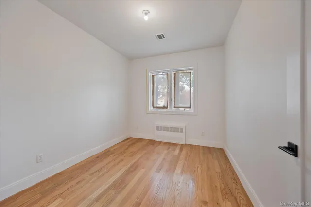 a view of a small space with wooden floor
