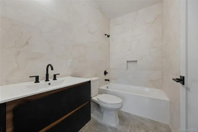 a bathroom with a sink a toilet and a bathtub