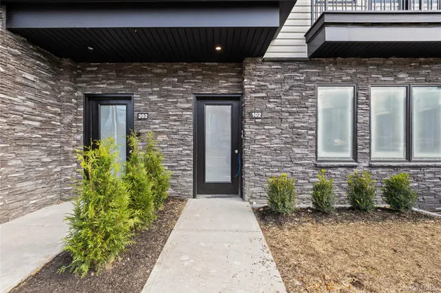 a view of a brick house with many windows