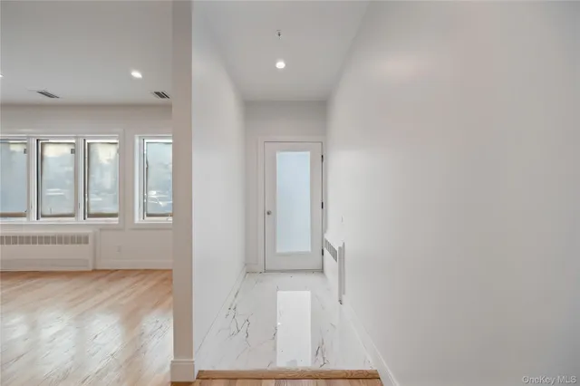a view of a hallway with wooden floor