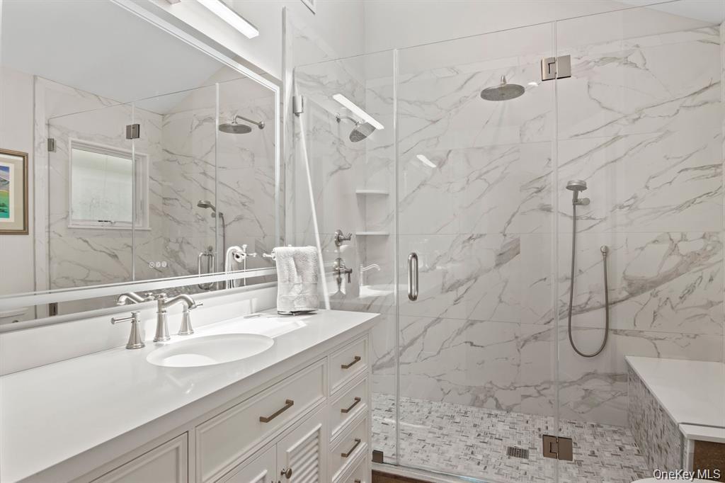 88 Dyke Road Setauket, NY 11733 - Photo 33 of 49 a bathroom with a granite countertop sink a shower and a mirror
