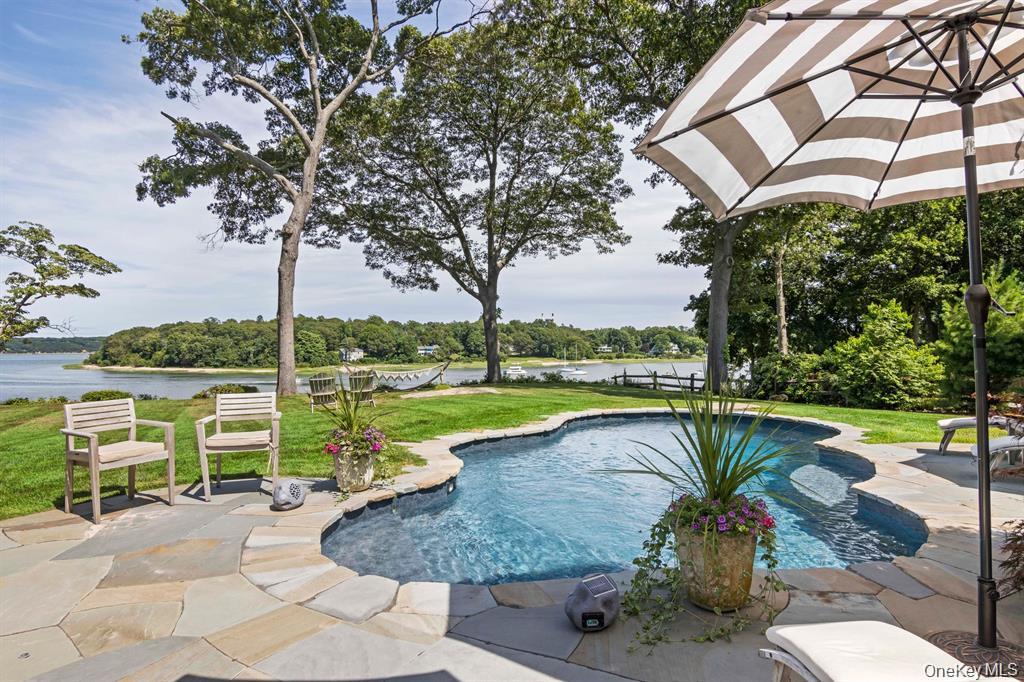 88 Dyke Road Setauket, NY 11733 - Photo 39 of 49 a view of a swimming pool with a patio