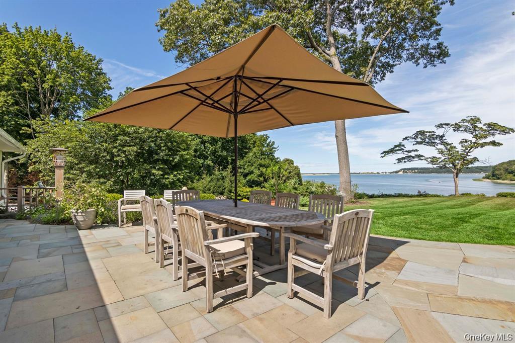 88 Dyke Road Setauket, NY 11733 - Photo 44 of 49 an outdoor space with furniture and umbrella