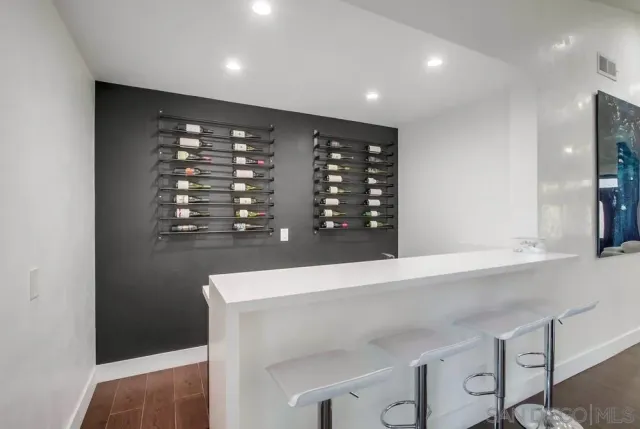 a kitchen with a refrigerator and a stove top oven