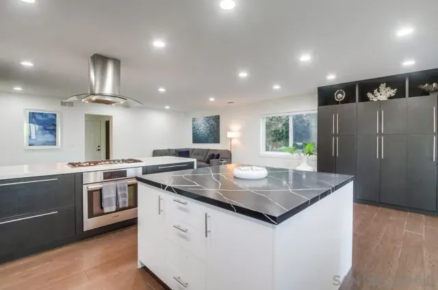 a living room with furniture a dining table and kitchen view