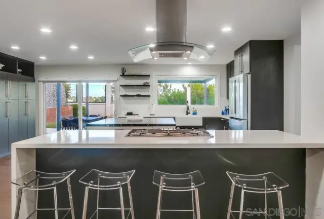 a bathroom with a granite countertop toilet sink and mirror